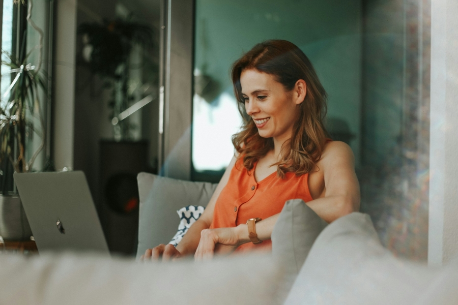 woman working on a computer and smiling