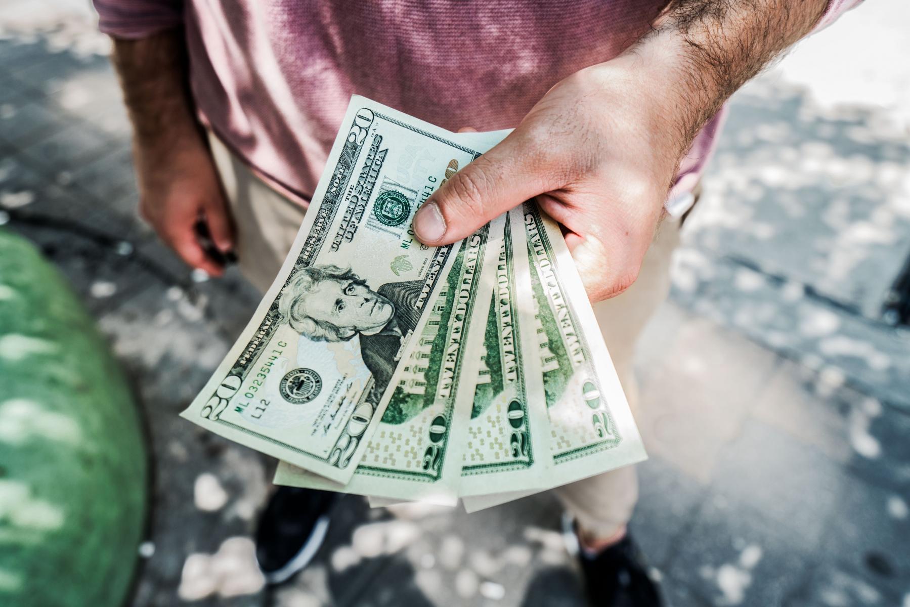 man holding lots of cash