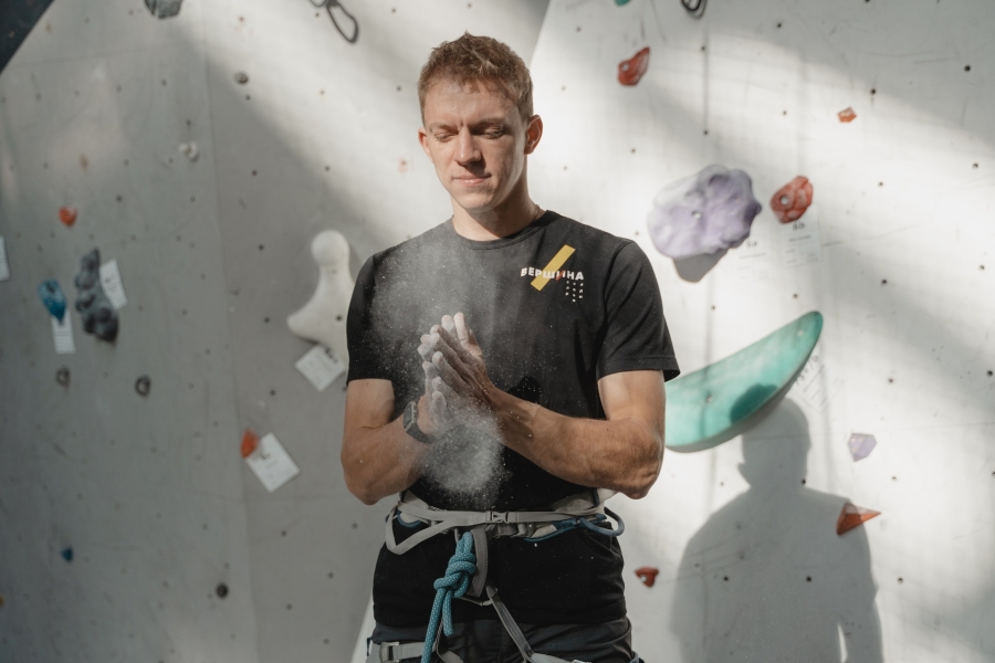 Man in Black Shirt Standing on Indoor Climbing Wall