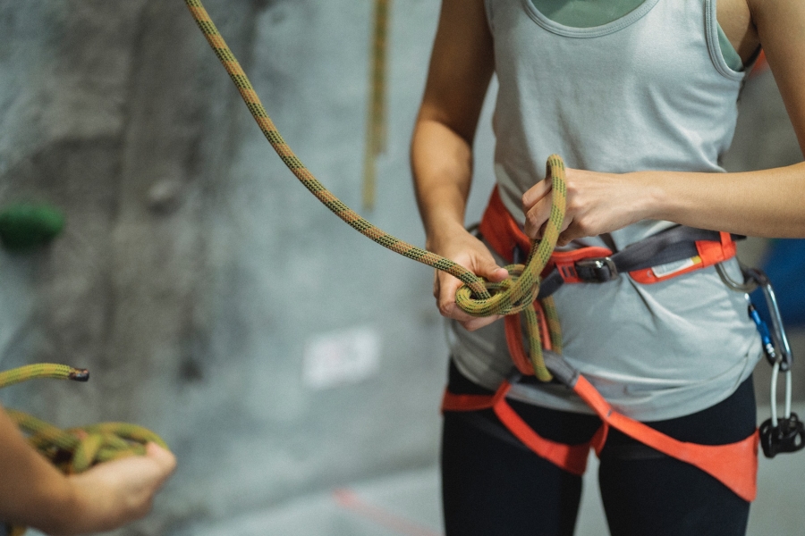 Crop climber tying safety rope during training