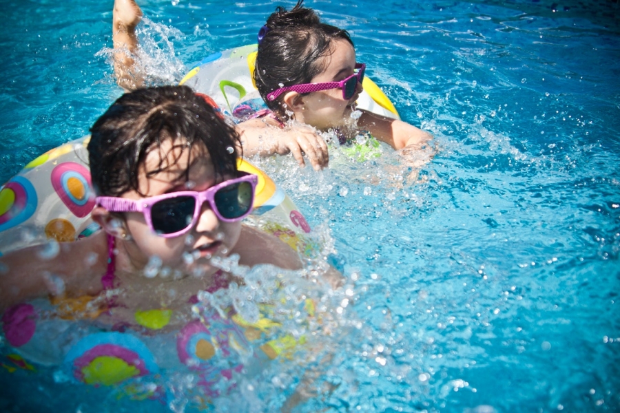 Two girls swimming in a pool