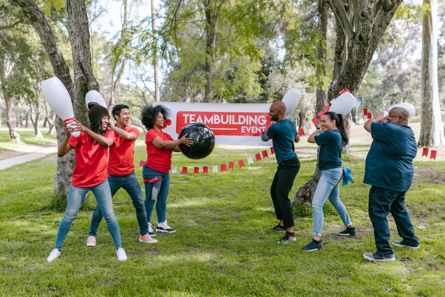 people holding toy bowling pins and playing the game